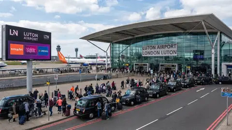 Minicab parked at Luton Airport drop-off area